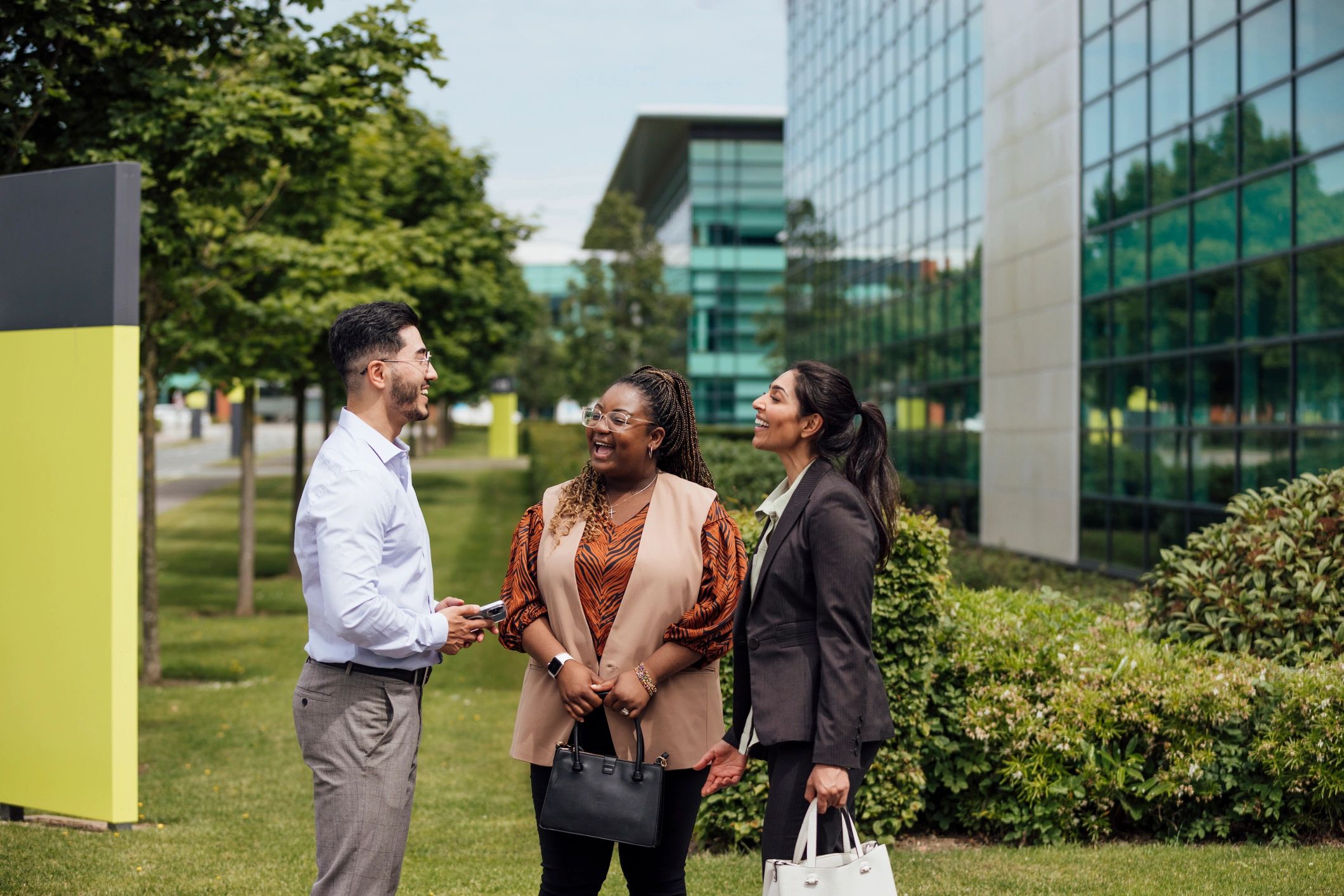 Professional colleagues in discussion outside an office building