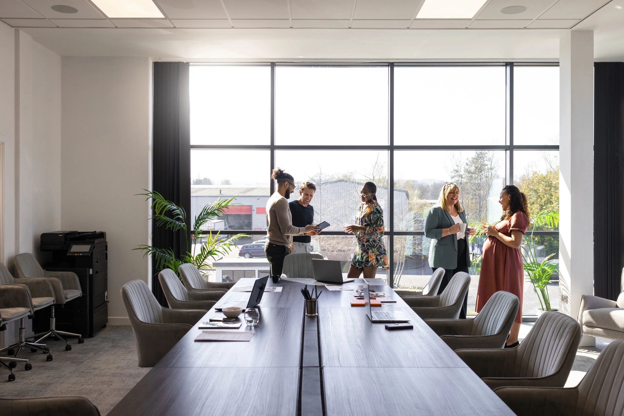 Colleagues discussing work in a modern office